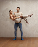 Strong man holding woman in his arms, both wearing Juzo Intenso