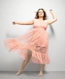 Woman with Juzo Inspiration and tights in almond and pink dress