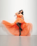 Woman with Juzo Inspiration and tights in cocoa and orange dress