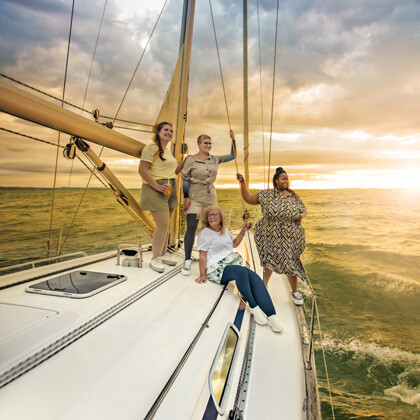 Four women with lymphatic conditions are on a boat at sea.