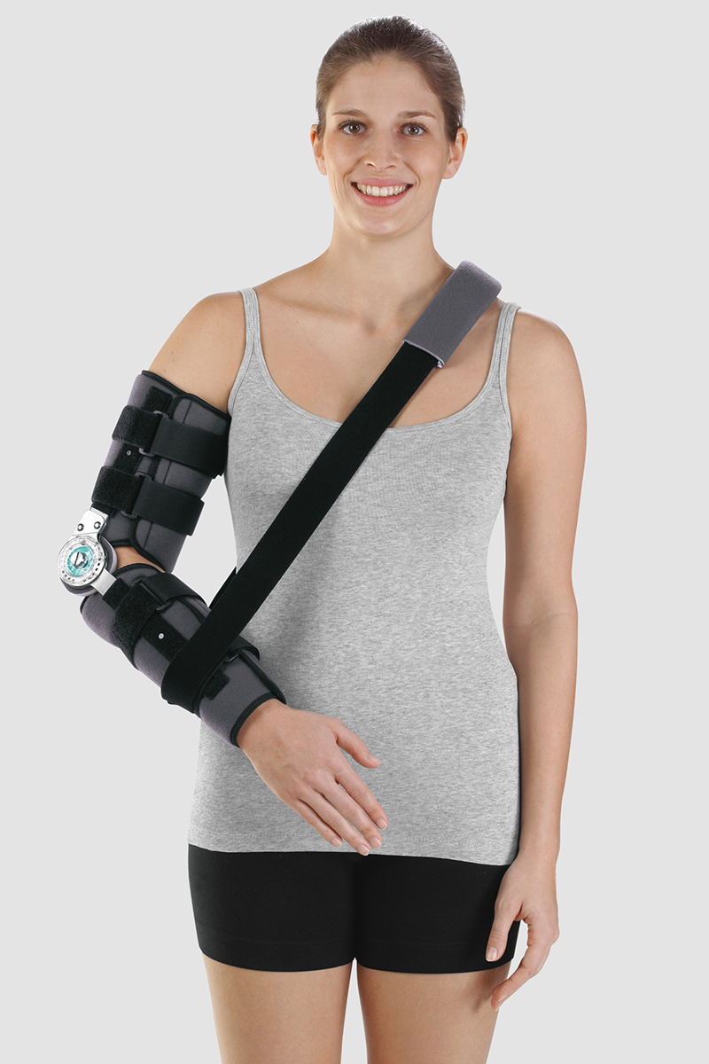 A woman wears an elbow orthosis